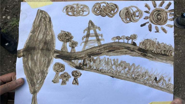 A finger painting  of the local landscape that has been painted using soil